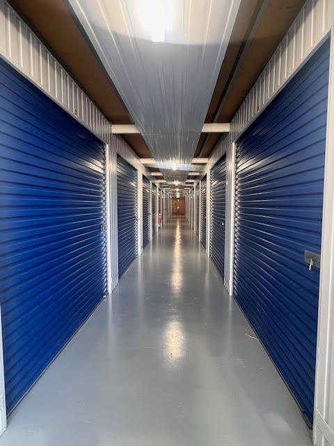 A warehouse with a lot of storage units with orange doors