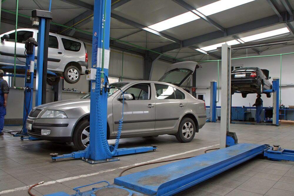A Car is Sitting on a Lift in a Garage — Dave's Used Cars In Stuart, NT