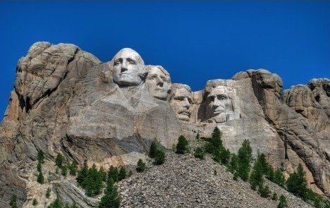 A mountain with a statue of four presidents on it