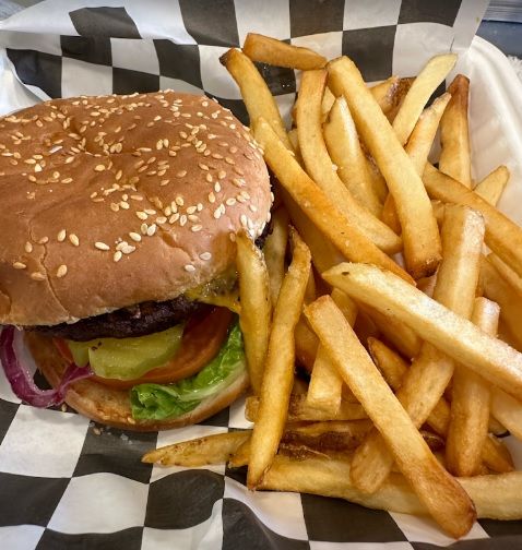 A hamburger and french fries on a checkered paper