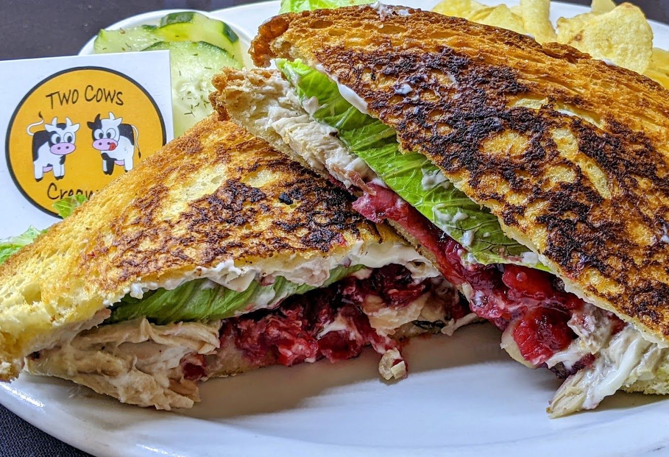 A close up of a sandwich on a plate with chips.