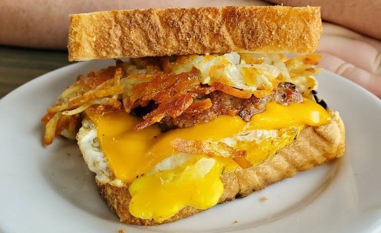 A close up of a sandwich on a white plate.