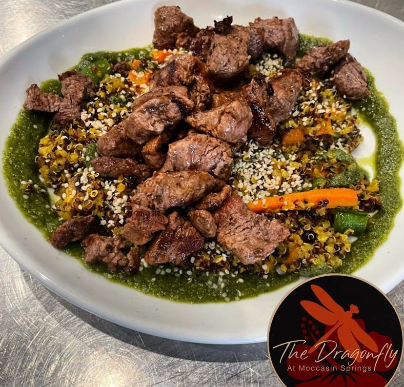 A plate of food with a dragonfly logo on it