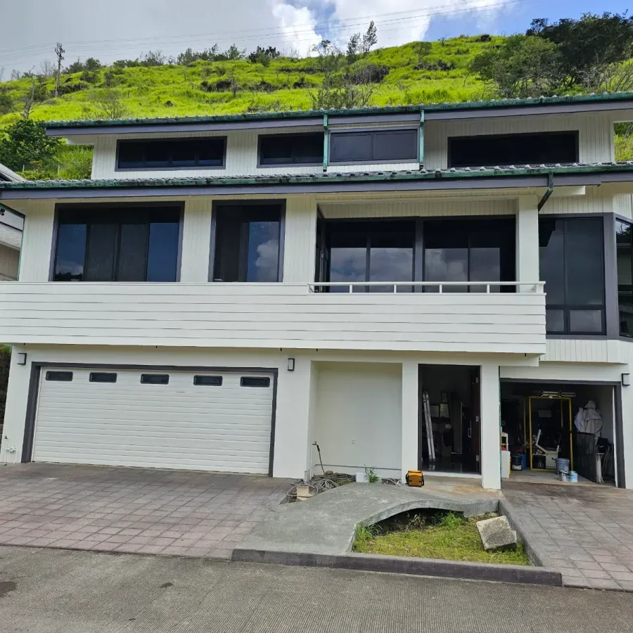 A large white house with a green roof
