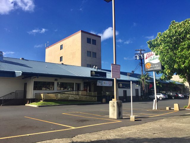 A large building with a parking lot in front of it