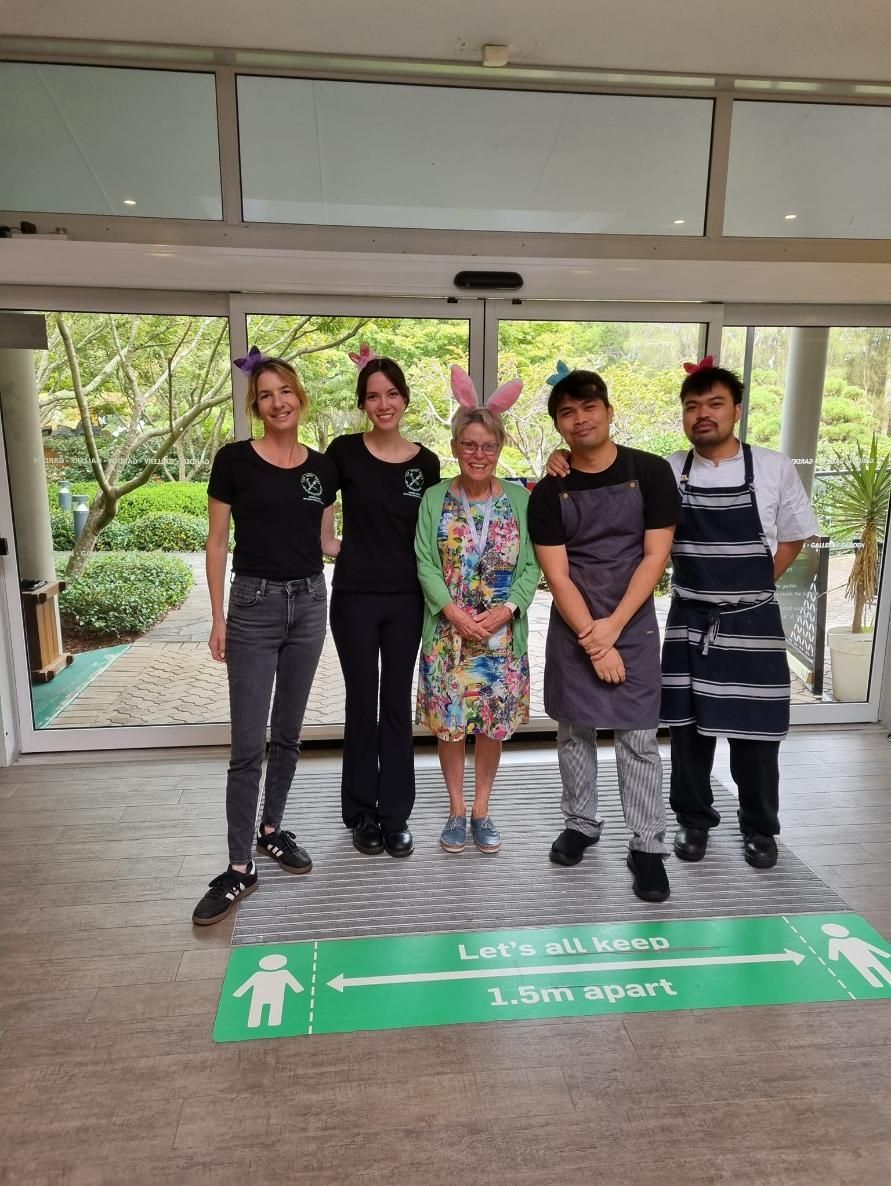 A Group Of People Standing Next To Each Other In A Room — Top Point Café In East Gosford, NSW