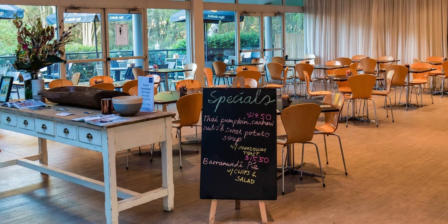 A Restaurant With Tables And Chairs — Top Point Café In East Gosford, NSW
