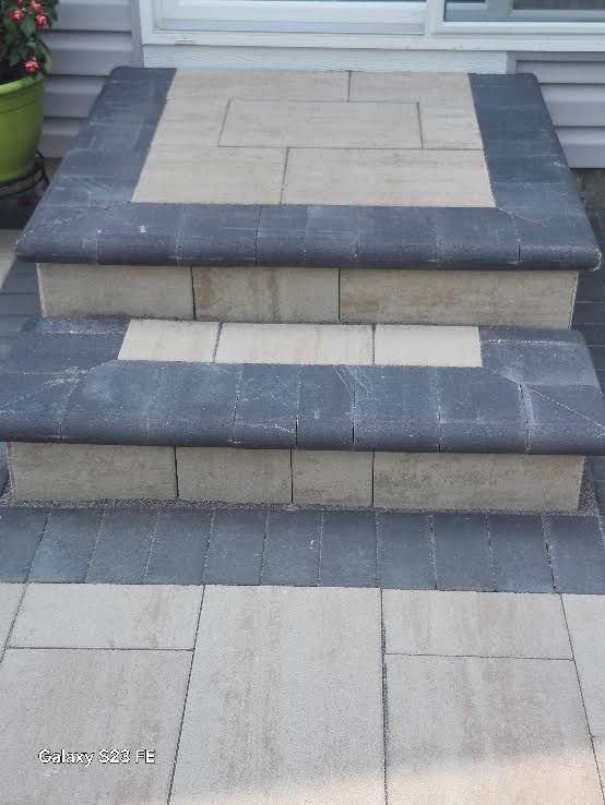 Stone steps with dark blue trim leading up to a front entryway
