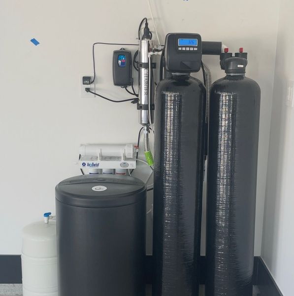 Two black cylinders are sitting next to each other in a room