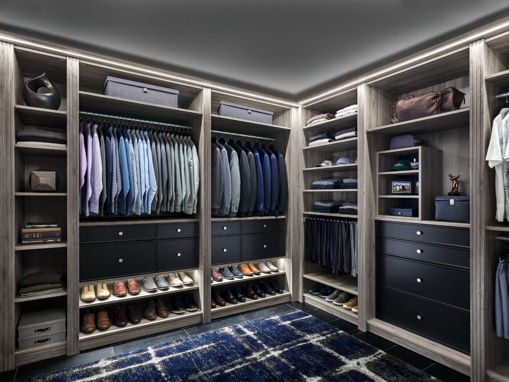 A walk in closet filled with lots of clothes and shoes.