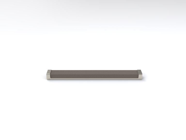 A metal bar is sitting on a white surface.