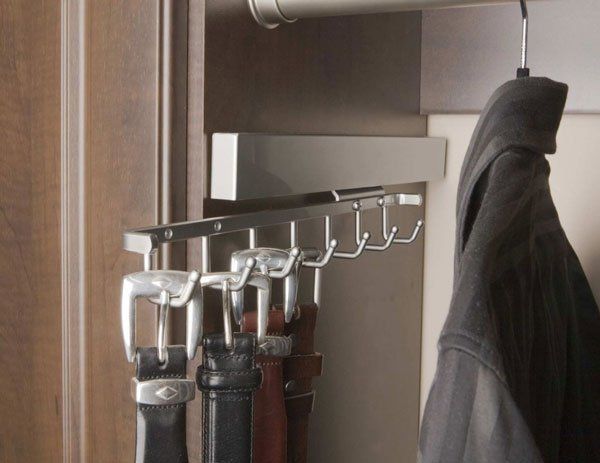 A coat is hanging on a hook in a closet
