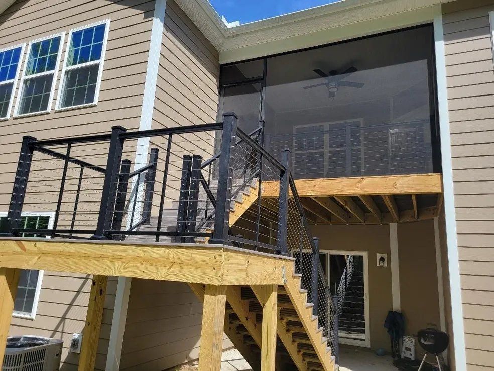 House deck with ramp and stairs leading to a screened porch