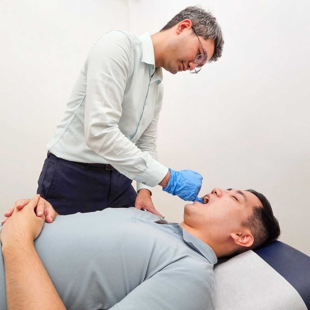 One Spine Chiropractic's chiropractor performing a chiropractic evaluation on a TMJ disorder patient