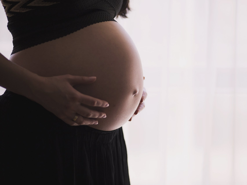 Pregnant holding belly