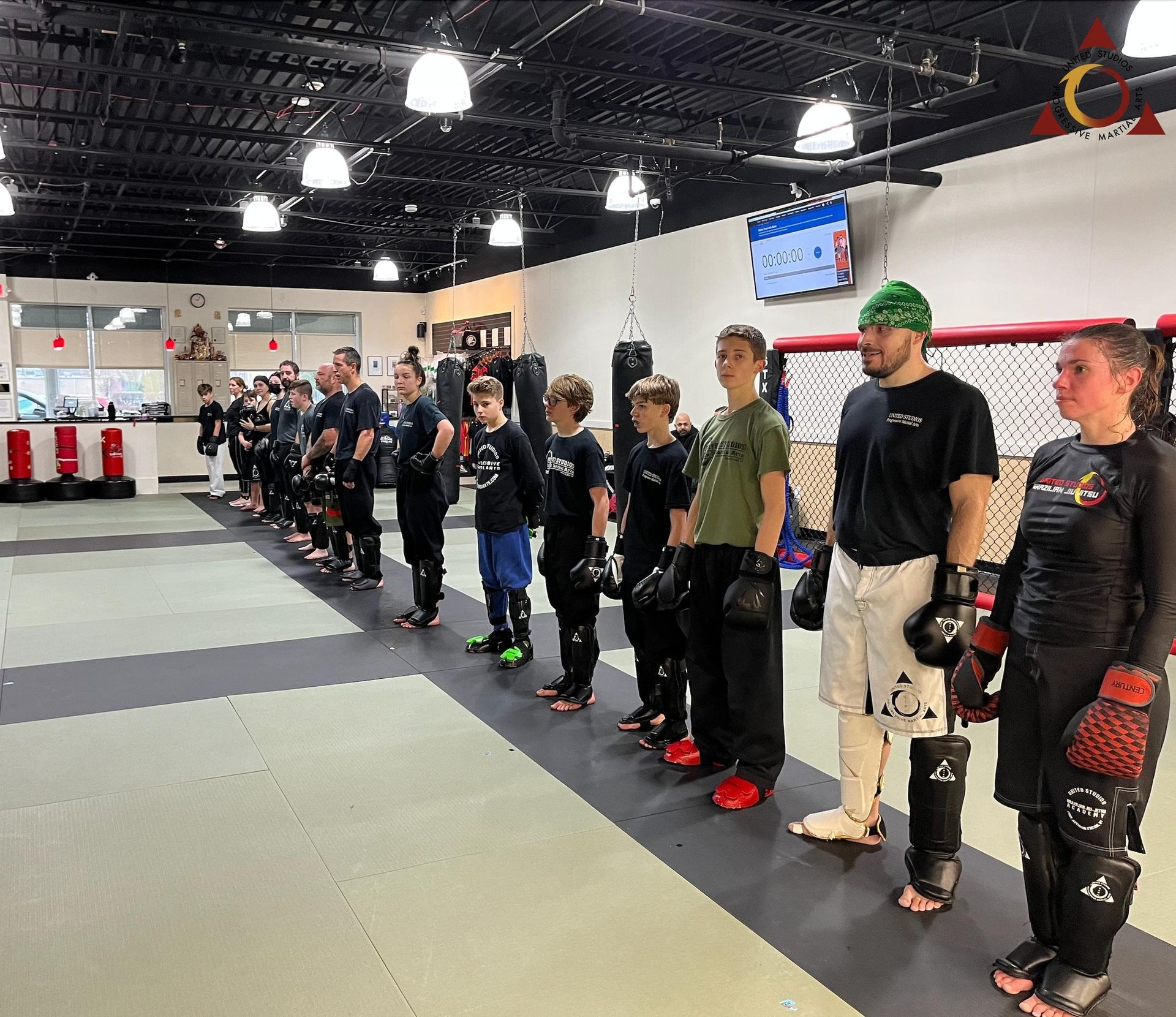 A group of people are standing in a line in a gym