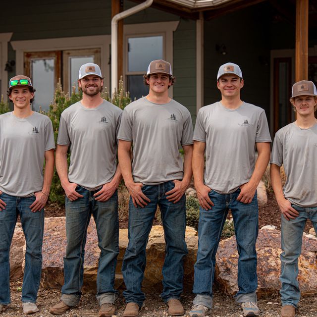 The Tarr Property Services crew standing in front of a finished landscape