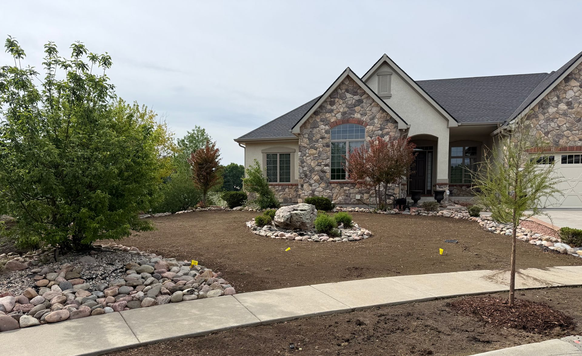 Rock water feature with boulders and plantings