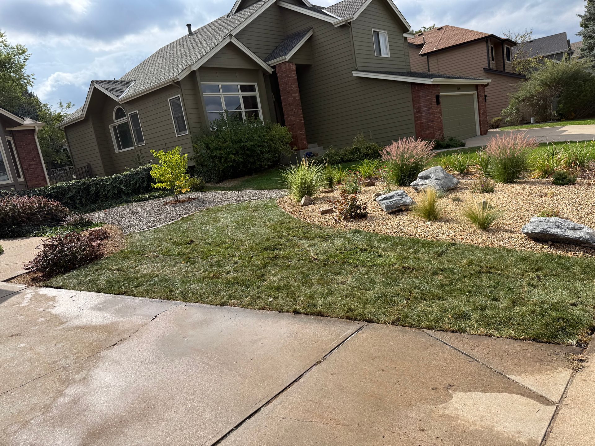 Well-kept landscape with a stone walkway and trimmed shrubs