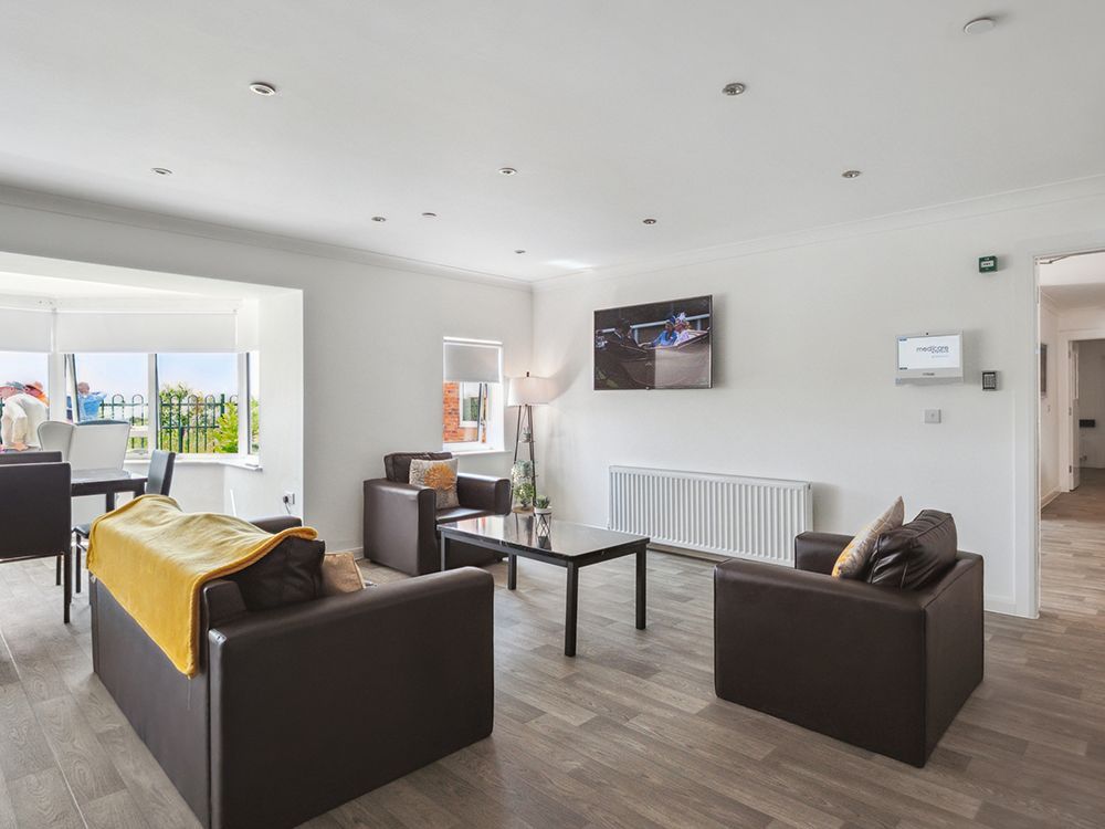 A living room with a couch , chairs , table and television at Arran View