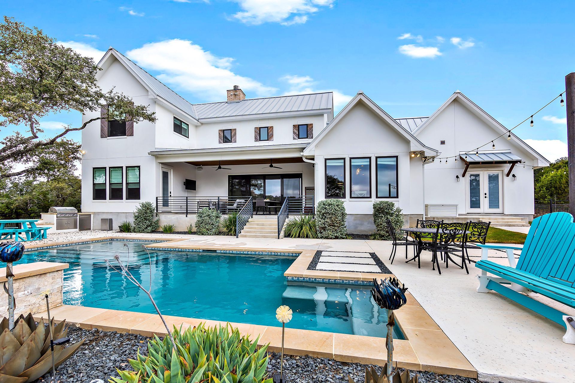 Sleek rectangular pool with spa, lounge chairs, and landscaped greenery. Sleek rectangular pool with spa, lounge chairs, and landscaped greenery.