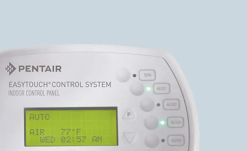 Pentair EasyTouch control panel with green display and illuminated buttons, showing 