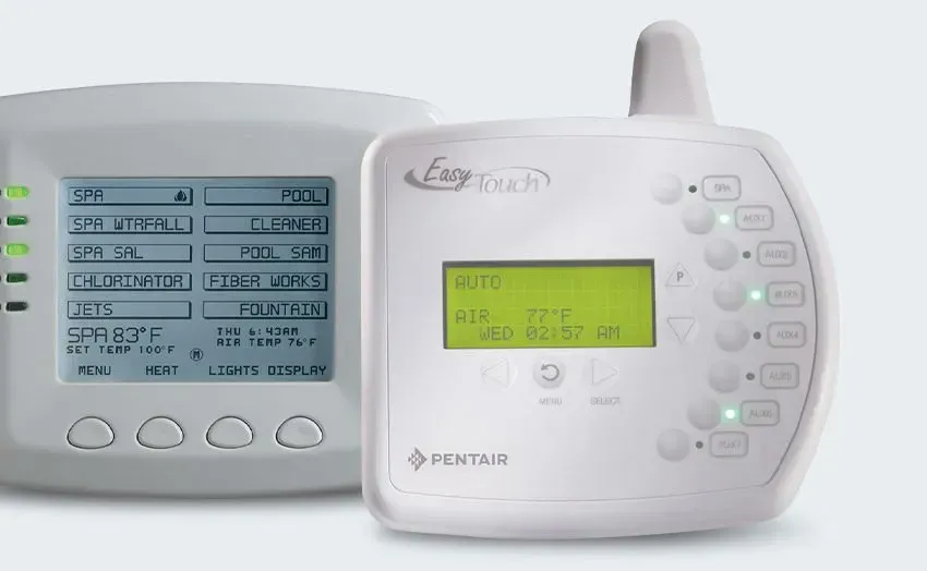A white thermostat and a wireless thermostat are sitting next to each other