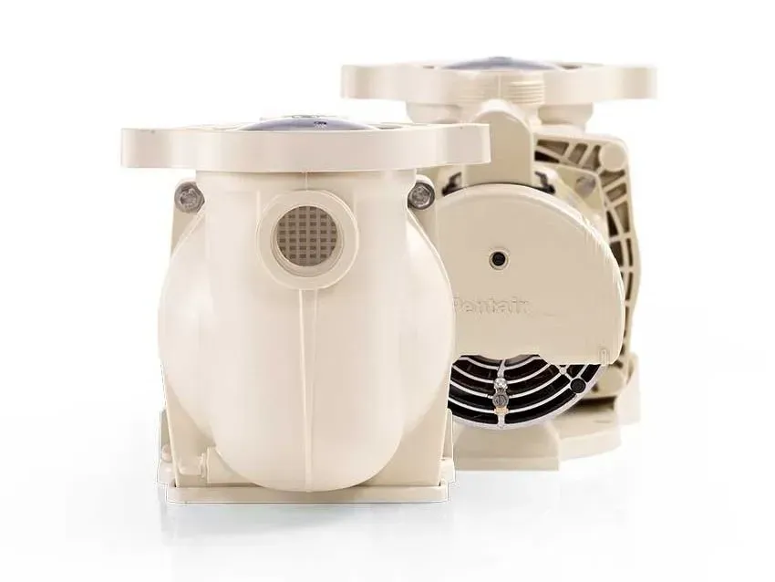 Two white swimming pool pumps are sitting next to each other on a white surface.
