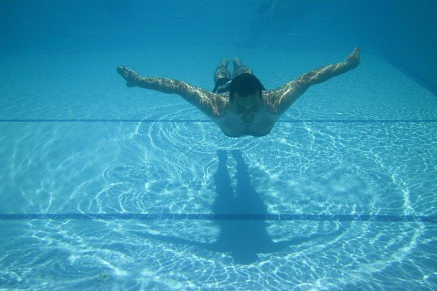 A Man Swimming in the Clear Blue Pool — Summerville, SC — Clearblue Pools A Man Swimming in the Clear Blue Pool — Summerville, SC — Clearblue Pools