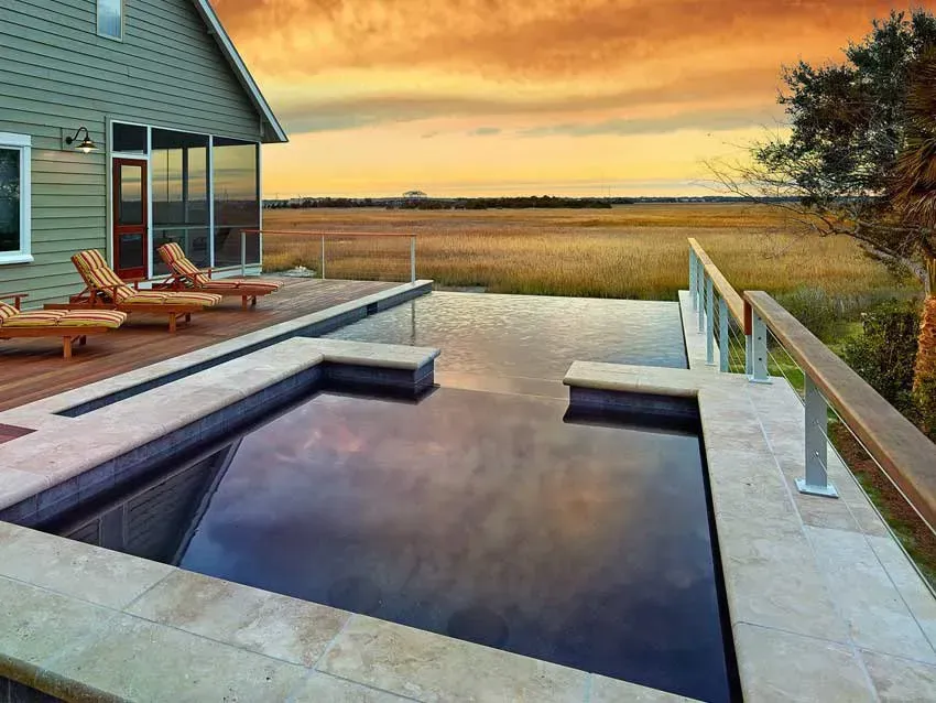 A house with a large swimming pool in front of it