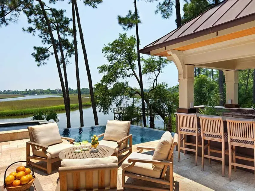 A house with a large swimming pool in front of it