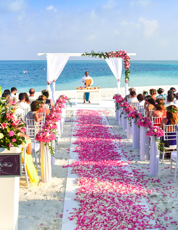 Beachfront destination wedding ceremony at a tropical resort