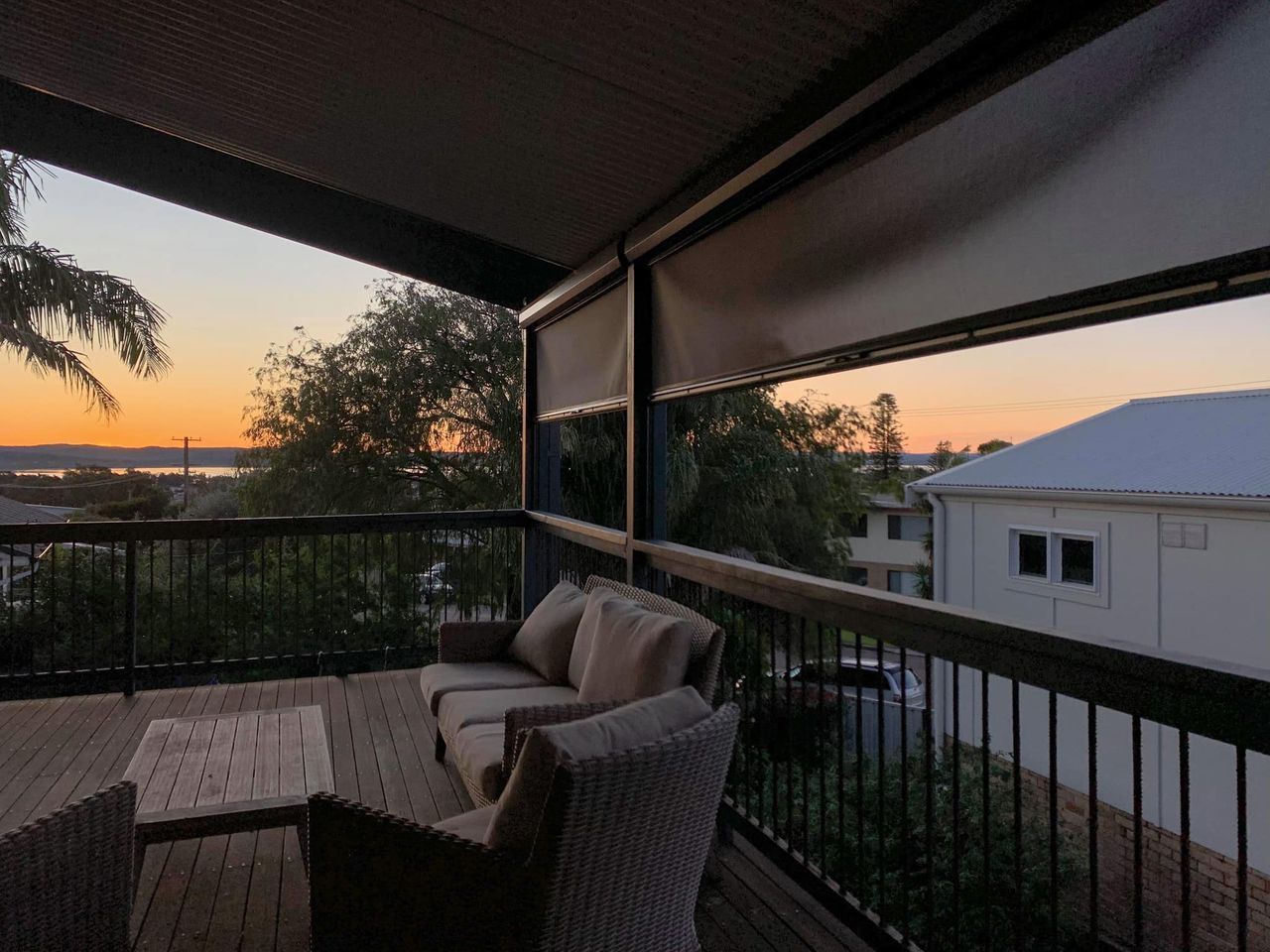 A Balcony With A View Of A Sunset — Ron Ayton Curtains, Blinds & Shutters In Shelly Beach, NSW