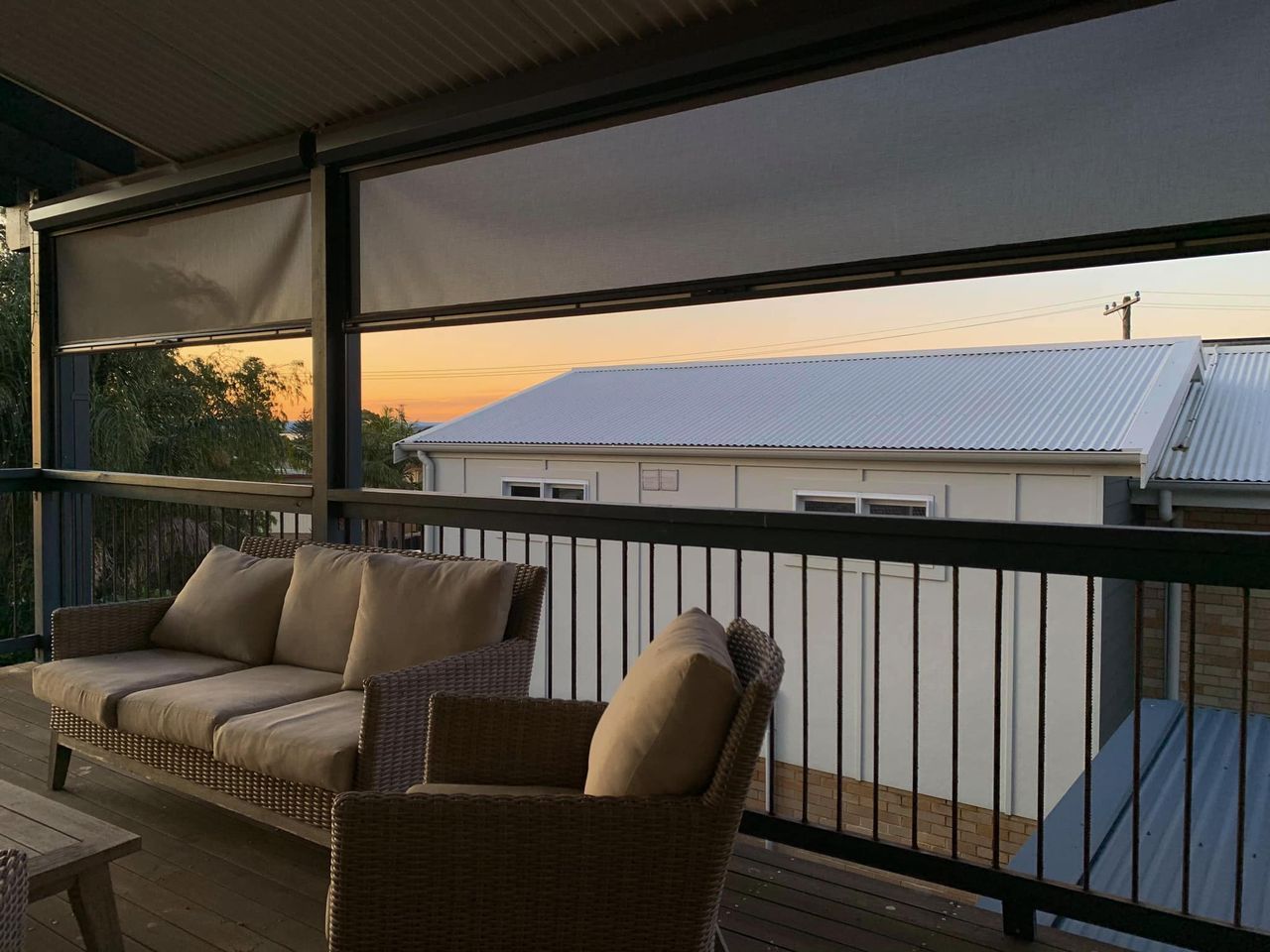 A Balcony With A Couch And Chairs — Ron Ayton Curtains, Blinds & Shutters In Gwandalan, NSW