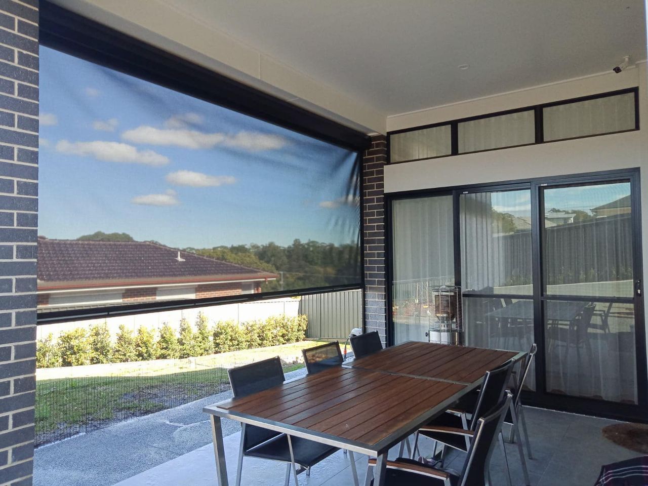 A Kitchen With A Long Table And Chairs And A Large Window — Ron Ayton Curtains, Blinds & Shutters In Shelly Beach, NSW