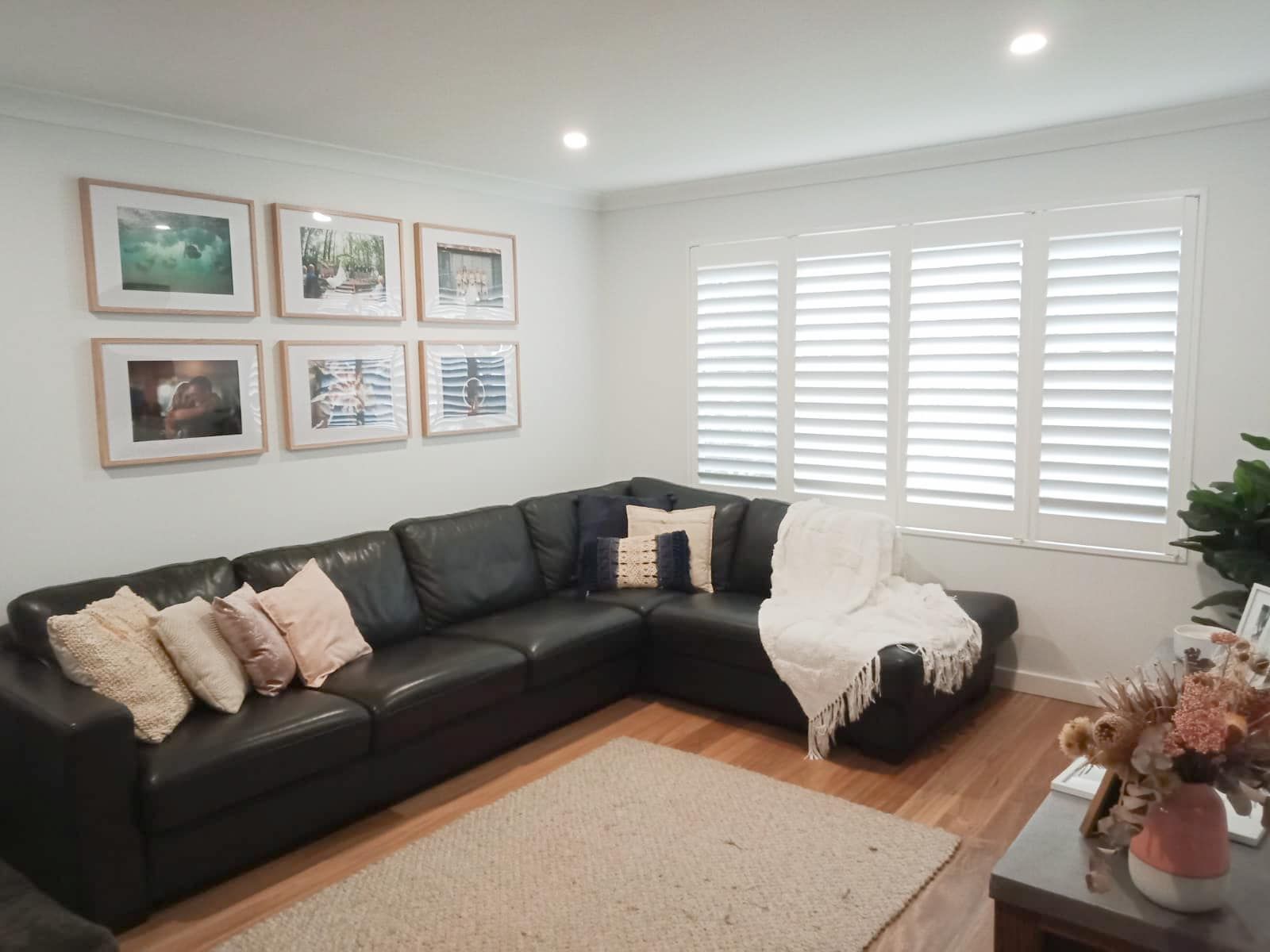 A Living Room With A White Shutters On The Windows — Ron Ayton Curtains, Blinds & Shutters In Terrigal, NSW