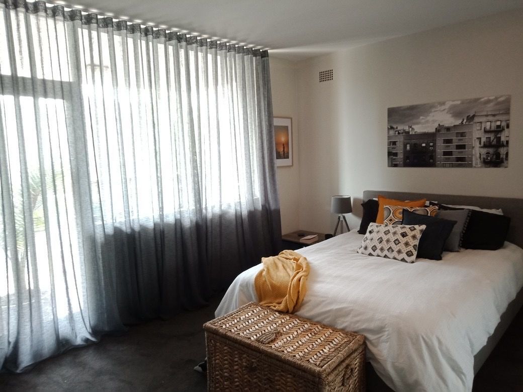 A Bedroom With A Window With Curtains — Ron Ayton Curtains, Blinds & Shutters In Shelly Beach, NSW