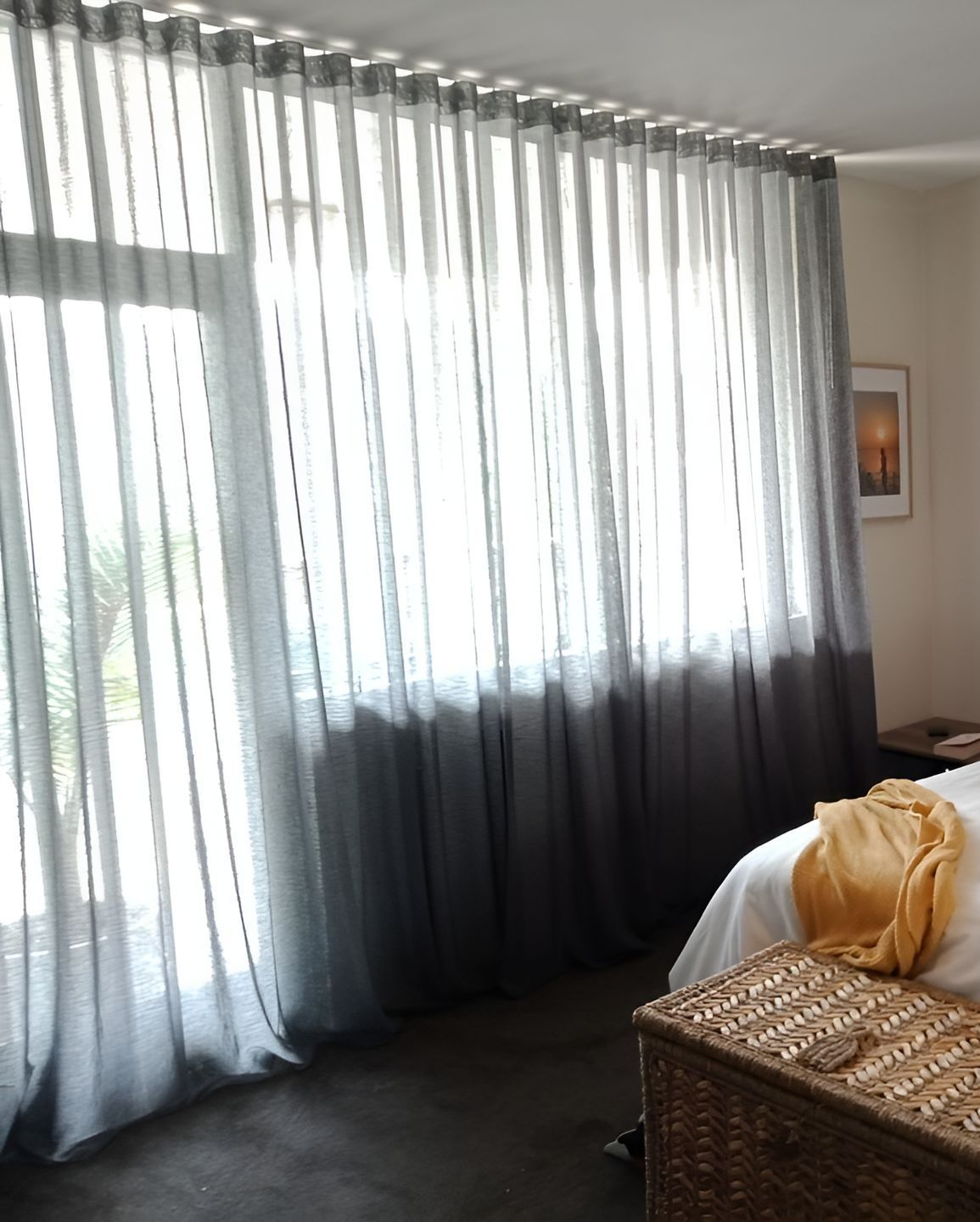 Sheer Gray Ombre Curtains Frame A Bright Window In A Bedroom