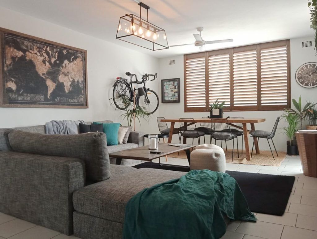 A Close Up Of A Metal Railing Between Two Windows — Ron Ayton Curtains, Blinds & Shutters In Shelly Beach, NSW