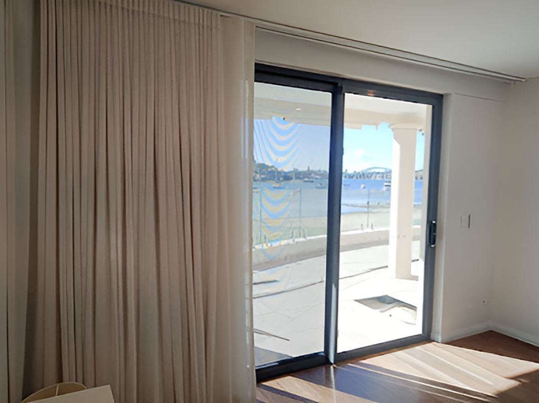 A Living Room With A Sliding Glass Door And Curtains — Ron Ayton Curtains, Blinds & Shutters In Shelly Beach, NSW