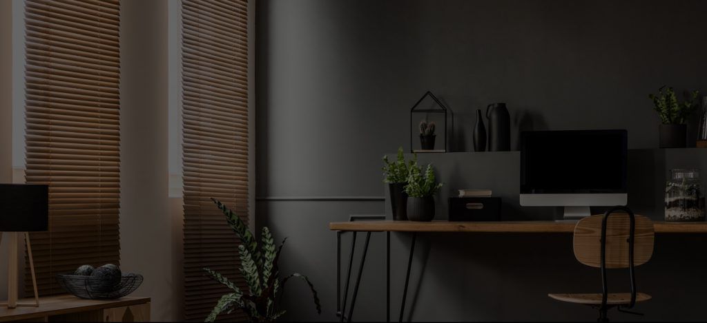 A Desk With A Computer On It In A Dark Room — Ron Ayton Curtains, Blinds & Shutters In Shelly Beach, NSW