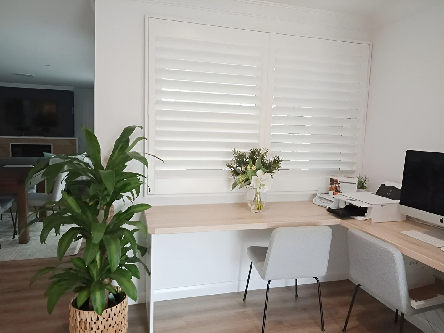 Home Office with Light Wood Desk, White Shutters, and a Potted Plant — Ron Ayton Curtains, Blinds & Shutters In Shelly Beach, NSW