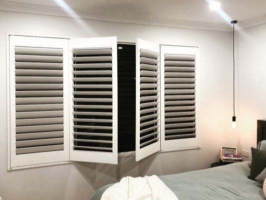 A Close Up Of A White Blind On A Window — Ron Ayton Curtains, Blinds & Shutters In Shelly Beach, NSW