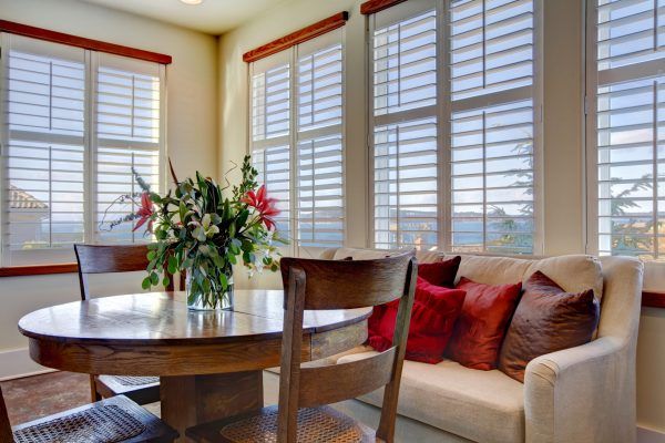 A Dining Room With A Table And Chairs — Ron Ayton Curtains, Blinds & Shutters In Shelly Beach, NSW