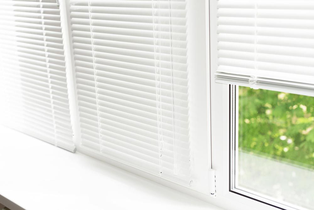 White Venetian Blinds By The Window