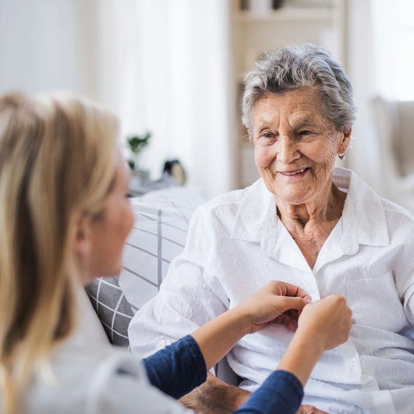 a woman assisting an elderly lady
