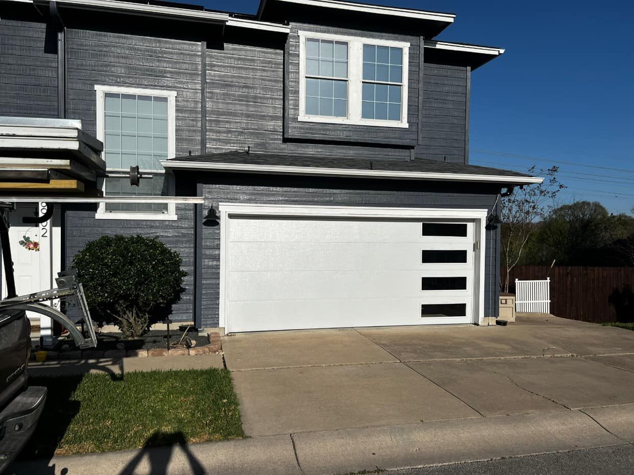 A gray house with a white garage door