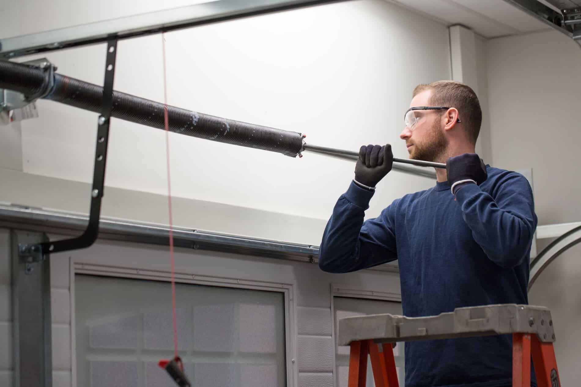 garage door technician replacing a spring