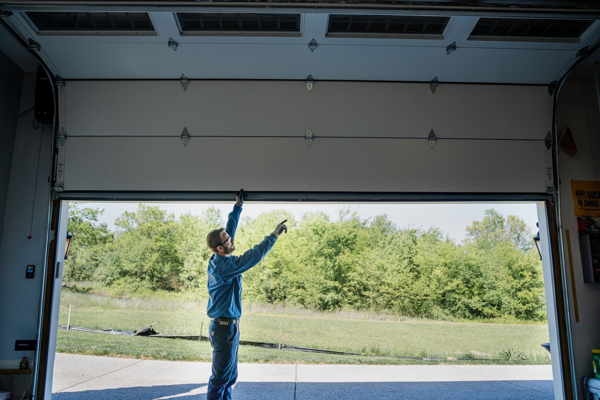 technician inspecting garage door damage
