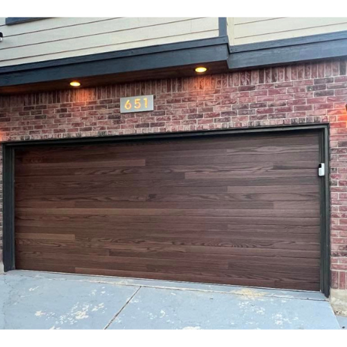 The garage door is made of wood and has a brick wall behind it.